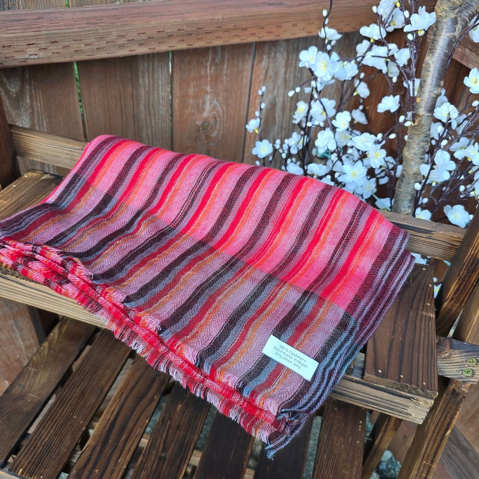 Folded multicolor cashmere scarf showing stripe pattern and Anitya handmade Nepal label