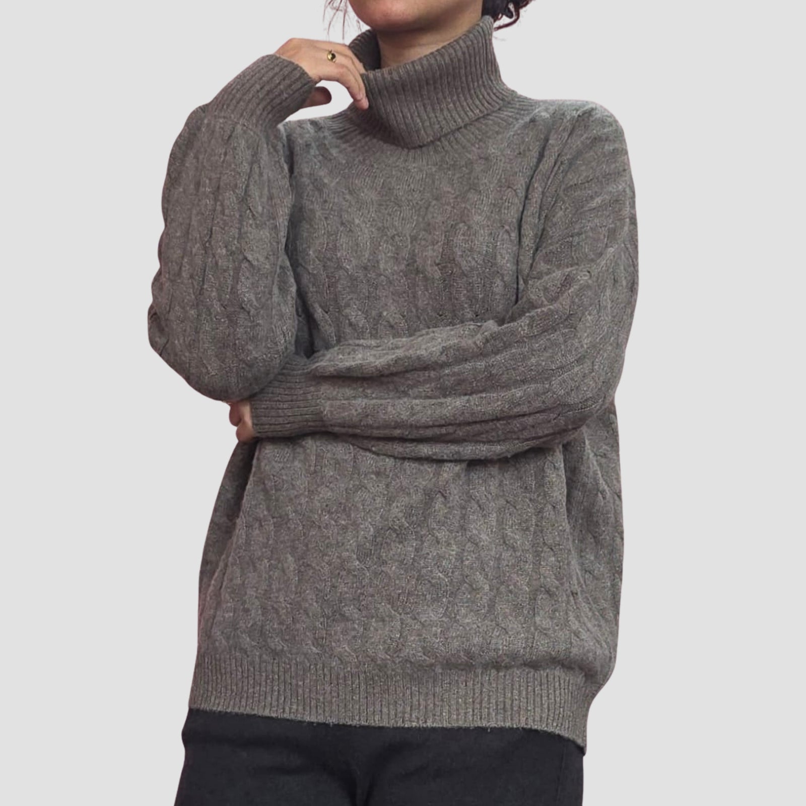 Woman wearing handknit cable cashmere turtleneck, classic warmth Nepal