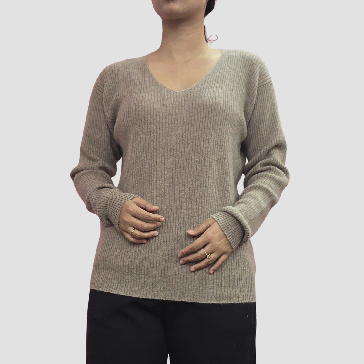 Woman wearing handknit cashmere V-neck sweater, elegant layering Nepal made