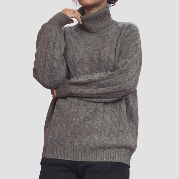 Woman wearing handknit cable cashmere turtleneck, classic warmth Nepal