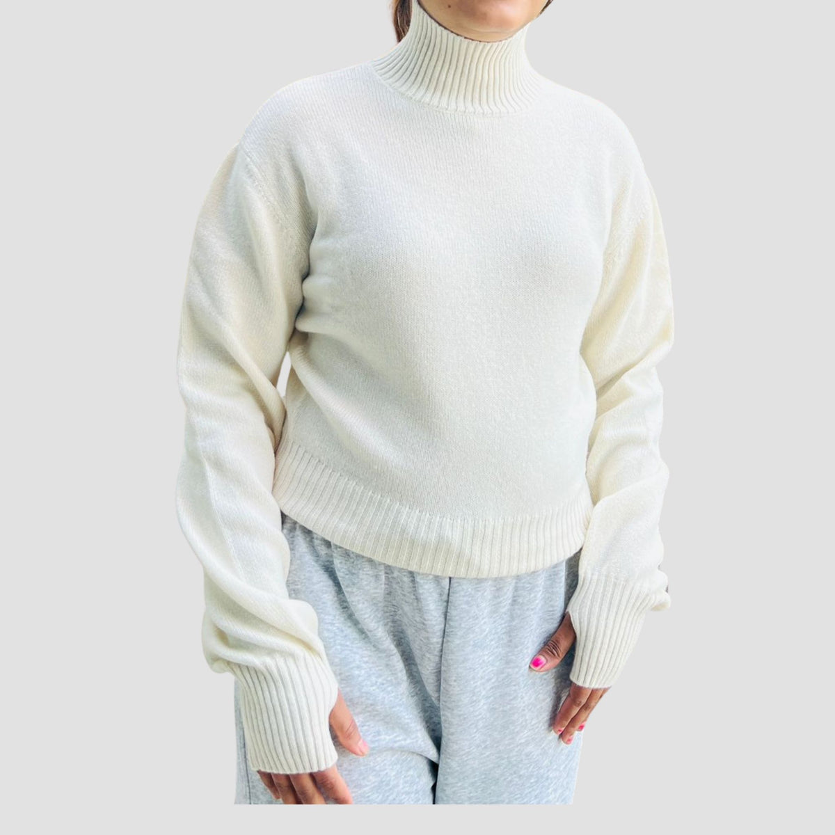 Woman wearing hand knitted cream cashmere sweater Nepal ethical fashion