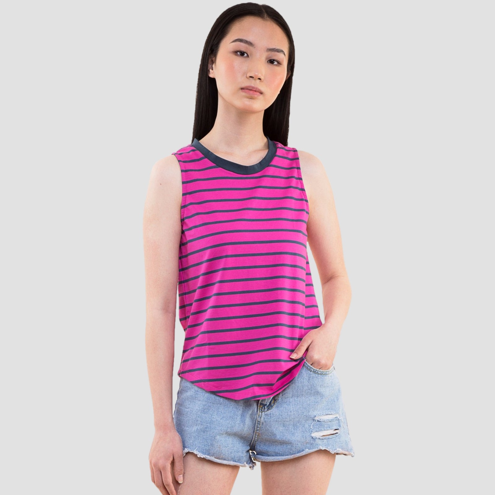 Woman wearing pink and navy striped sleeveless casual top