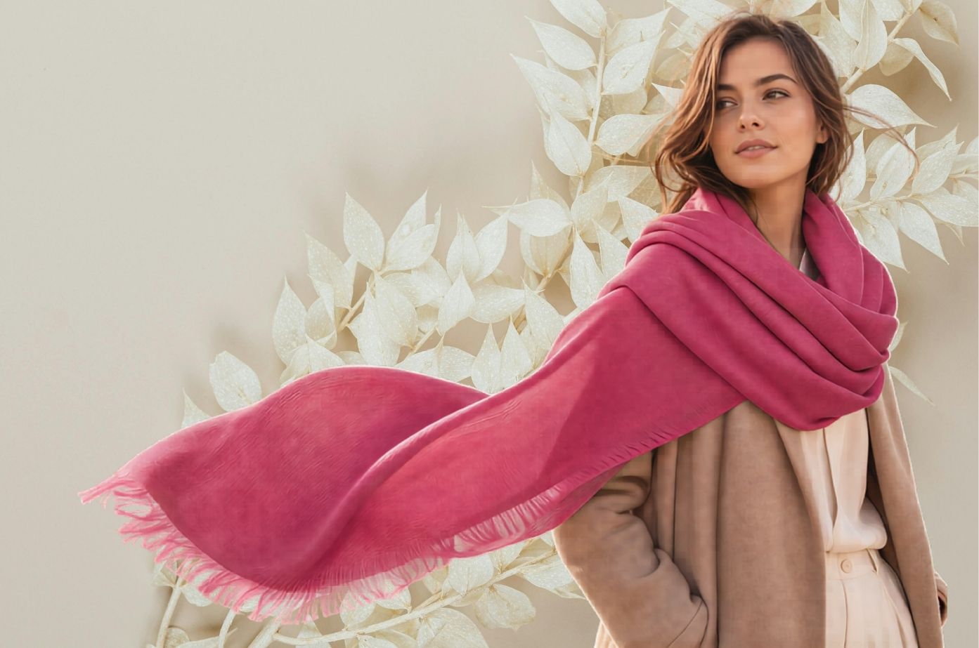 Woman wearing a pink scarf with a neutral background