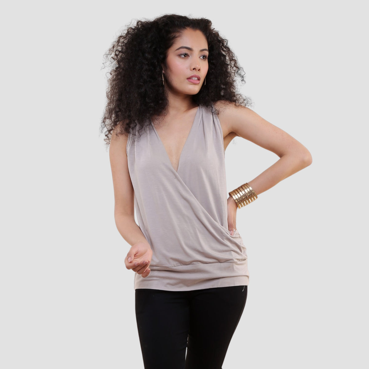 Woman wearing organic cotton draped wrap top in vegetable-dyed beige color
